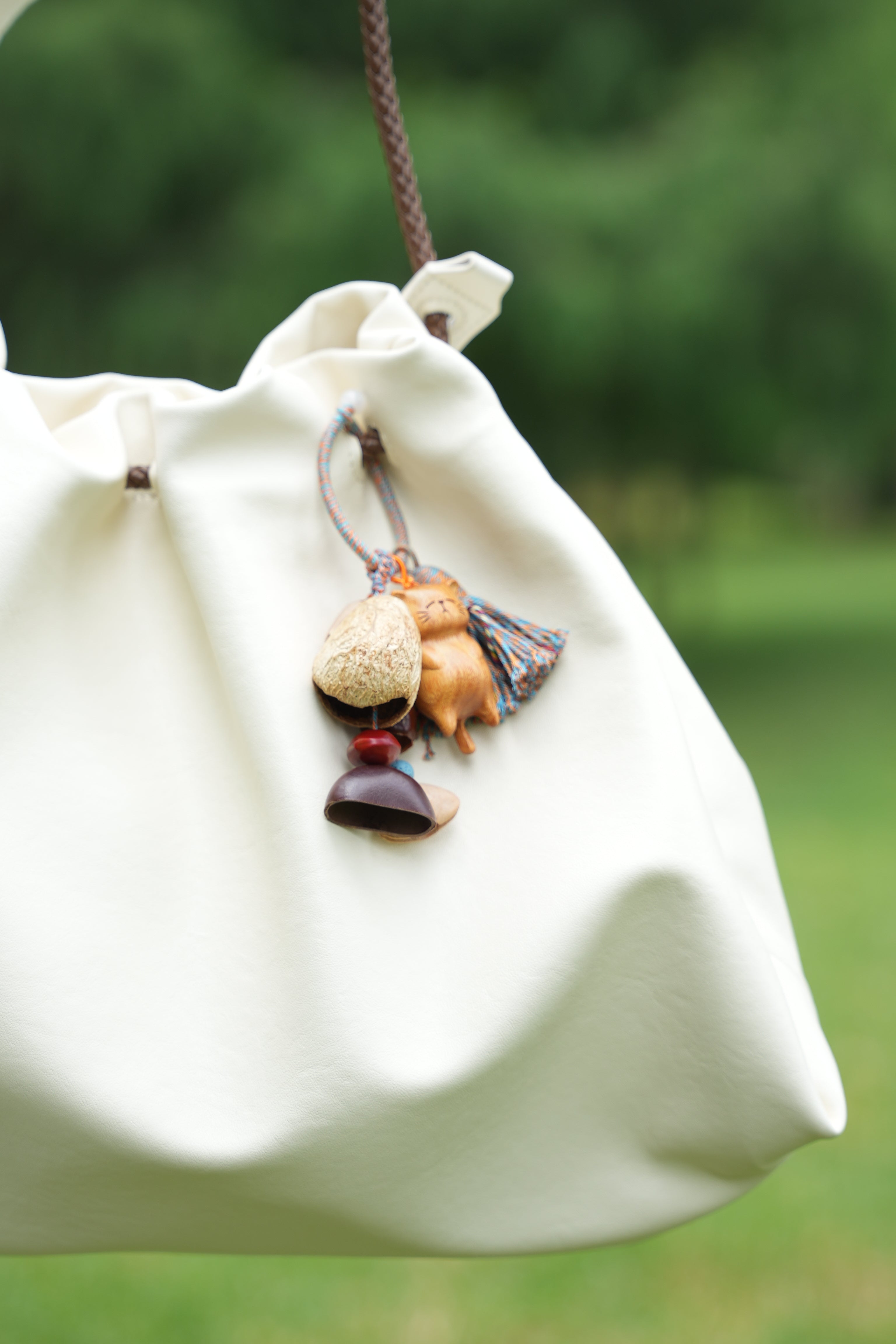 "The Naptime Kitty" - Hand-Carved Wooden Cat Charm with Natural Seeds & Tassel