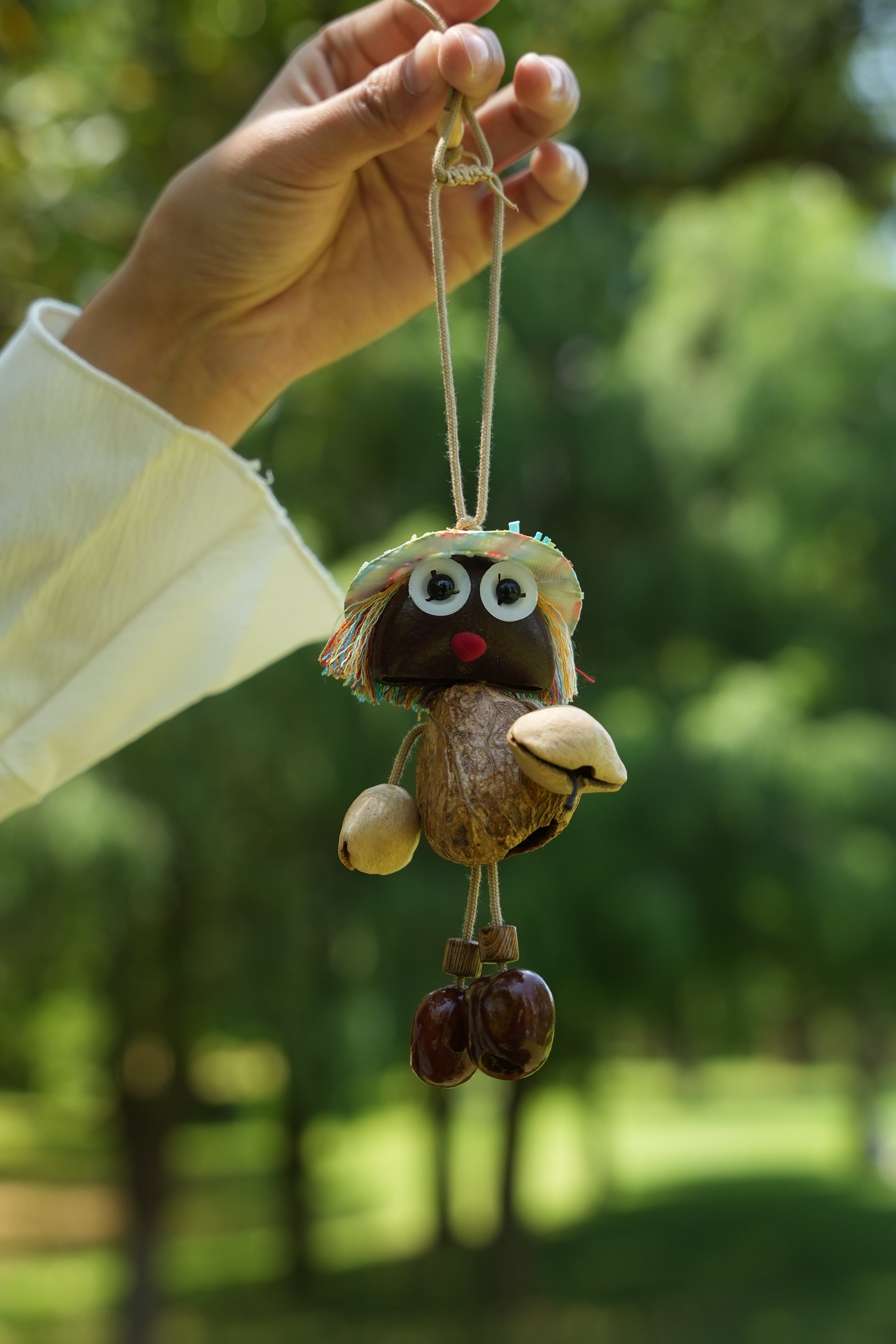 "The Seed Sprite" - Handcrafted Nut Shell Doll Charm with Colorful Fringe Hair