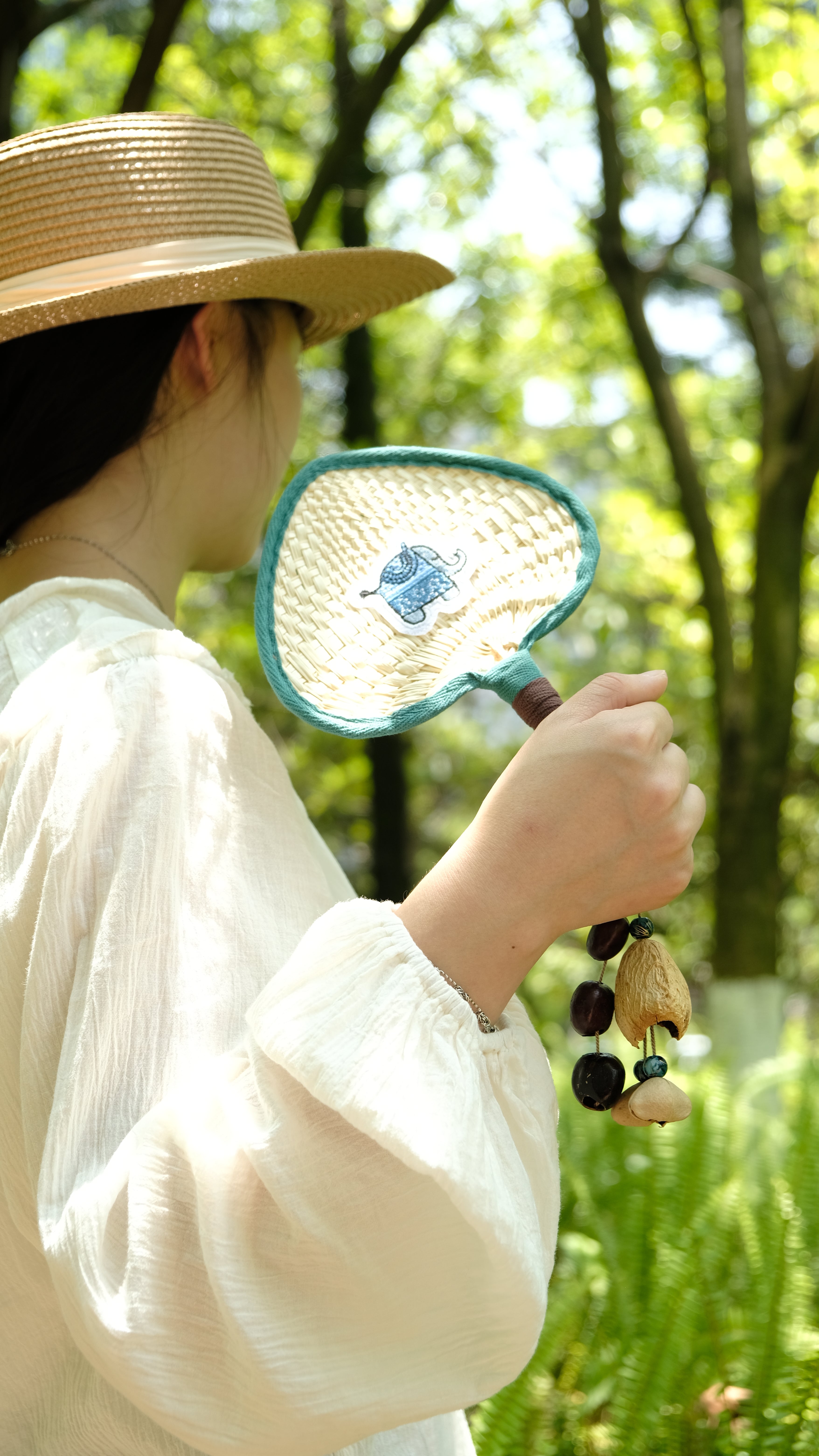 "The Lucky Breeze" - Hand-Woven Heart Palm Fan with Blue Elephant & Seed Charm